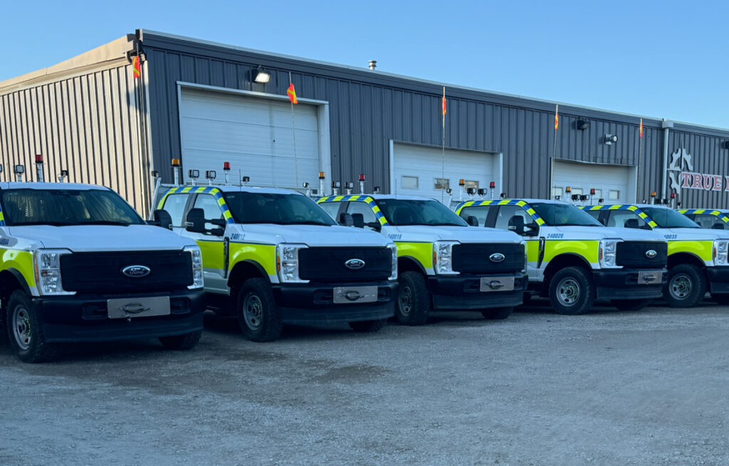 Fleet trucks in a row outside shop
